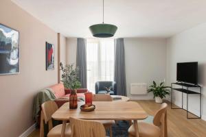 a living room with a table and a couch at Cove Paradise Street in Liverpool