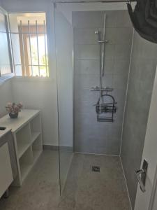 a bathroom with a shower with a glass door at La Verdière in Barjols