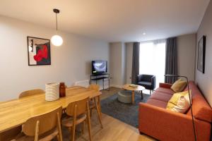 a living room with a couch and a table at Cove Paradise Street in Liverpool
