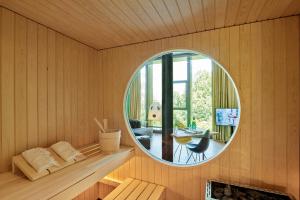 a room with a round mirror in a sauna at Studios & Spa Suites Rigiblick in Zurich