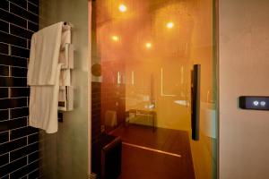 a bathroom with a shower with a sink and a towel at Studios & Spa Suites Rigiblick in Zurich +28 photos