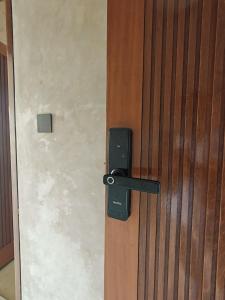a wooden door with a lock on it at Nawang Sakti in Ubud