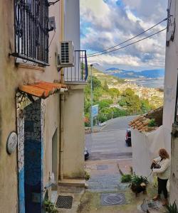 a woman taking a picture of a building at La MARUZZELLA in Vietri sul Mare