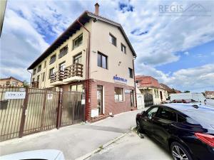 a black car parked in front of a building at Barrique 24-4 - Breakfast delivered & Minibar - Free Parking -Officially classified guesthouse in Braşov