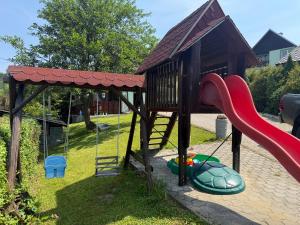 a playground with a slide and a play structure at Chatka Hanka in Terchová