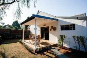 a small white house with a blue roof at 19 Mare St Apartments in Howick