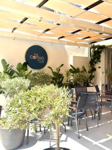 a restaurant with tables and chairs and plants at The Convo Athens Riviera in Athens +34 photos