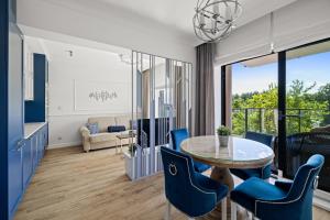a living room with a table and chairs at Lake Rental Spacerowa in Mikołajki