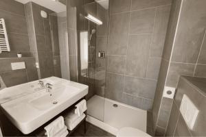 a bathroom with a sink and a shower and a toilet at Hôtel Golf Fontcaude in Montpellier +30 photos