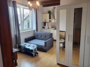 a living room with a blue couch and a table at Villa Patria Wadowice in Wadowice