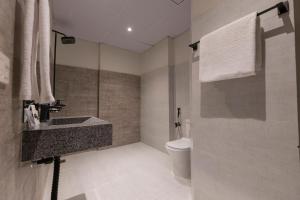 a bathroom with a sink and a toilet at The Address Boutique Hotel Karachi in Karachi