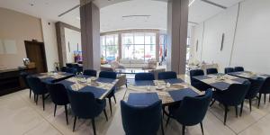 a group of tables and chairs in a room at Basra Platinum Hotel in Al Başrah