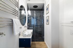 a bathroom with a sink and a shower at Lake Rental Spacerowa in Mikołajki +81 photos