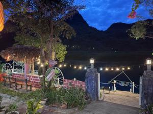 a string of lights over a lake at night at Son River House in Phong Nha