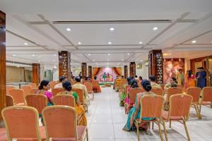 a group of people sitting in chairs in a room at FabHotel Prime Nakshatra Inn in Hyderabad
