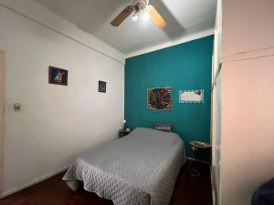 a bedroom with a bed and a blue wall at Casa Olivos in Olivos