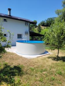 a house with a swimming pool in a yard at Apartmani Lucica in Jajce