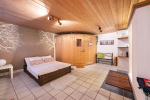 a bedroom with a bed and a wooden ceiling at Weibhauser Franzl in Ruhpolding