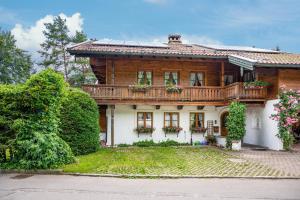 a wooden house with a balcony on top of it at Weibhauser Franzl in Ruhpolding