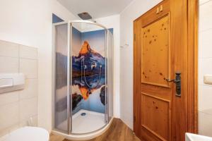 a shower with a glass door in a bathroom at Weibhauser Franzl in Ruhpolding +37 photos