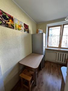 a small room with a table and a refrigerator at Кандавас 9 in Daugavpils