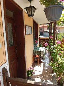 an outdoor patio with a bench and flowers at Guest Rooms Dona in Koprivshtitsa