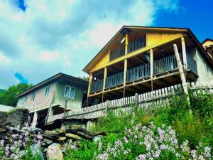 a house on a hill with flowers in front of it at Elo's Guesthouse in Iprari