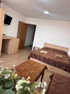 a hotel room with two beds and a table at Very good location in Hunedoara