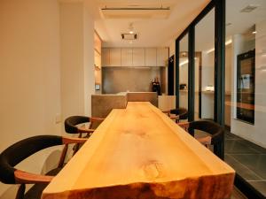 a long wooden table in a room with chairs at THE SENSE HOTEL TOKYO in Tokyo