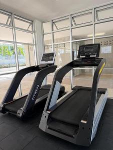 two treadmill machines in a gym with windows at Sufi Idaman Studio for Islamic only in Nilai