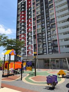 a playground in front of a tall apartment building at Sufi Idaman Studio for Islamic only in Nilai