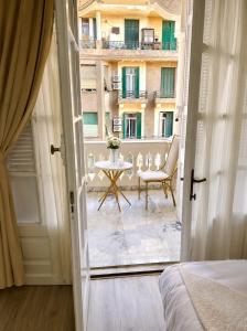 a room with a bed and a table and a building at Qasr court in Cairo