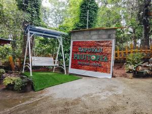 a sign that says navajo rhodota next to a bench at Tapovan Fruitopia in Sultan Bathery +1 photo
