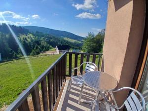 a table and chairs on a balcony with a view at Vila Golijat in Raška