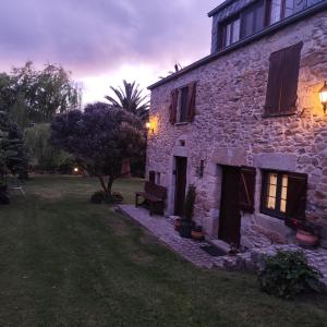 an old stone house with a bench in the yard at Rego de Cora By Oktheway in Valcarría +45 photos