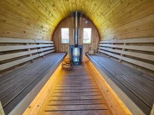 an empty sauna with wooden walls and wooden floors at Agroturystyka Golubie in Ełk