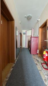 an empty hallway with a red refrigerator in a room at Casa Elvezia Guest House in SantʼElpidio a Mare