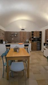 a large kitchen with a wooden table and chairs at Villa Dar La Belle Beyah - Tezdaine in Taguermess