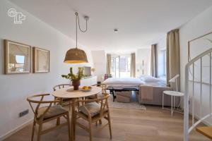a living room with a table and a bed at Haus Nordstrand in Norderney