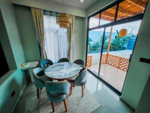 a dining room with a table and chairs and a window at Matemwe Bluu Villa in Matemwe