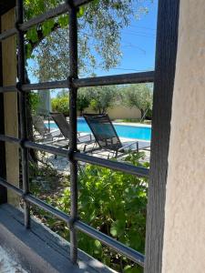 a view of a pool through a window at Saily Beach Hotel in Koropi