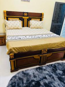 a bedroom with a bed with a wooden frame at Villa Diamaguene in Ngaparou +12 photos