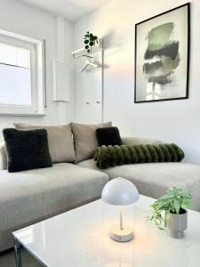 a living room with a couch and a table at Heide Apartments in Schneverdingen