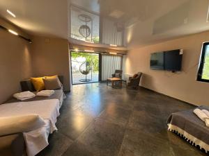 un soggiorno con due letti e una televisione di hotel Labyrinth pool a Tbilisi City