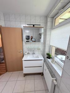 a bathroom with a sink and a mirror at Am Stadtrand in Chemnitz +39 photos