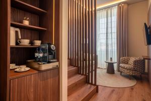 a living room with a door to a room with a window at The Book Hotel in Horta