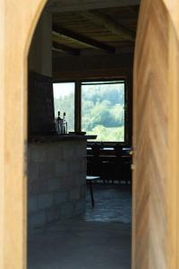 an open doorway to a restaurant with a table and windows at Bungalow Volk Turjaški in Gabrovka
