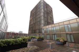 a large building with some plants in a courtyard at Cove Paradise Street in Liverpool