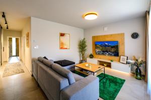 a living room with a couch and a table at Victory port Apartmán in Liptovský Mikuláš