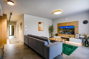 a living room with a couch and a table at Victory port Apartmán in Liptovský Mikuláš